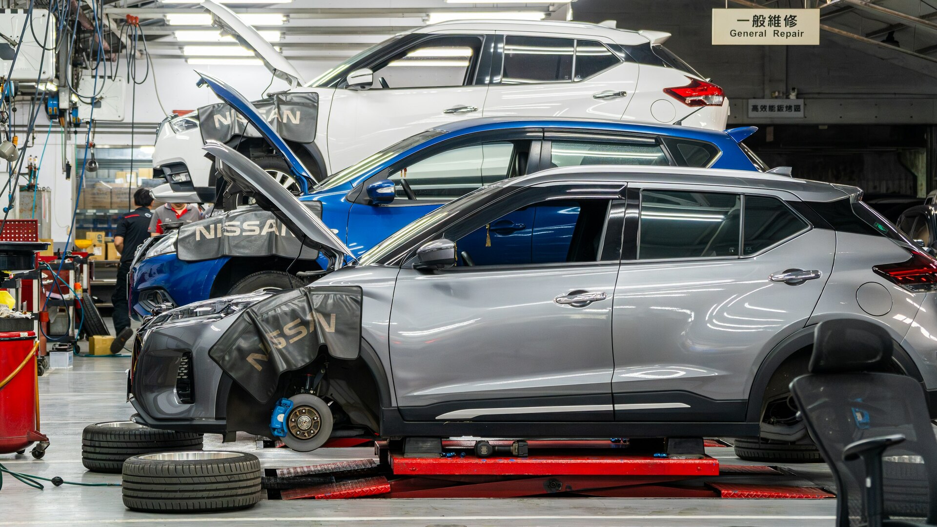 Auto service team coordinating workshop jobs